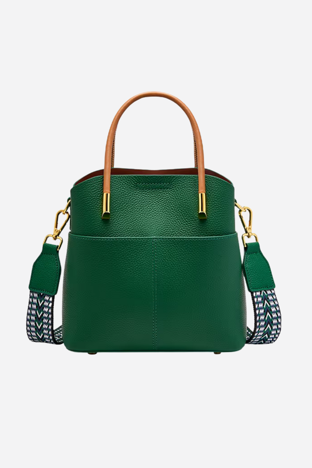 Green handbag with brown handle and patterned strap on a light gray background