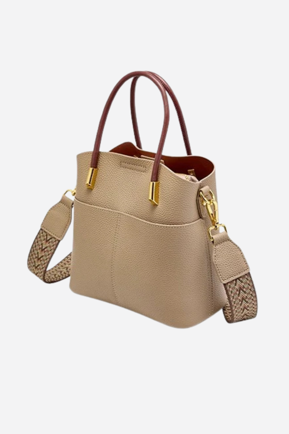 Beige handbag with brown handles and strap on a white background