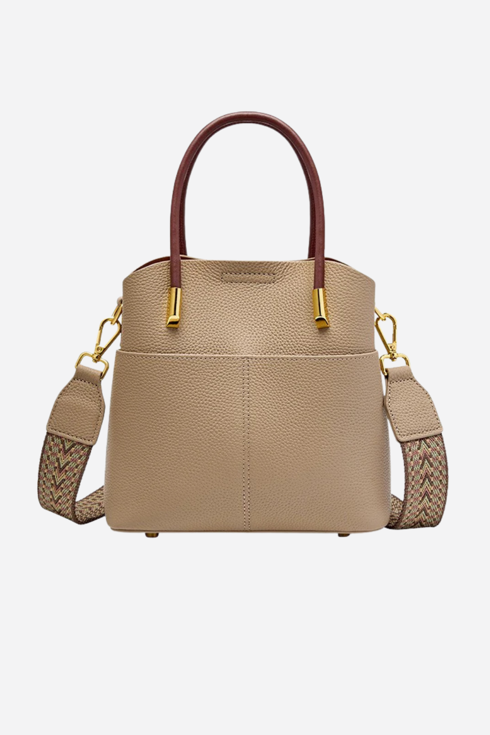 Beige handbag with brown handles and braided strap on a white background